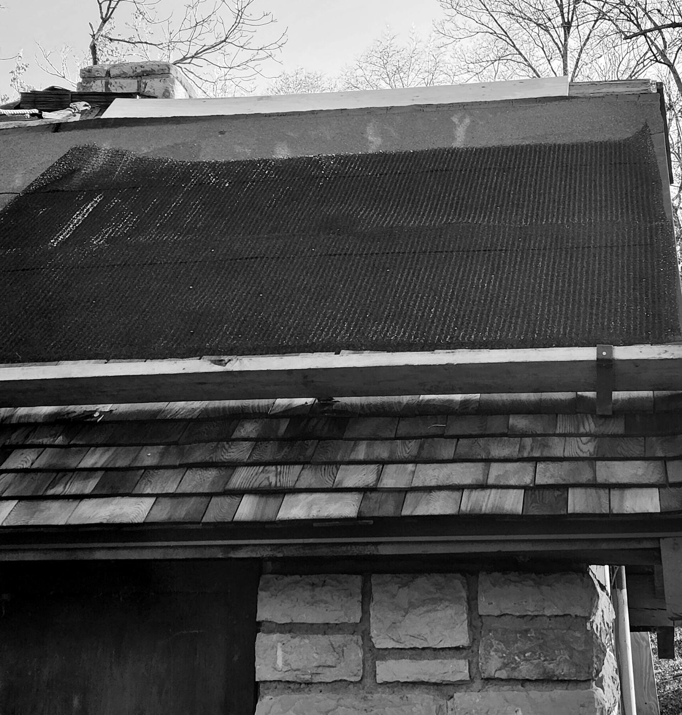 New shingles and underlayment partway through a roof replacement